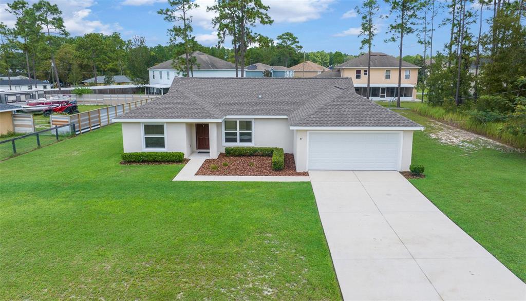 a front view of a house with a yard