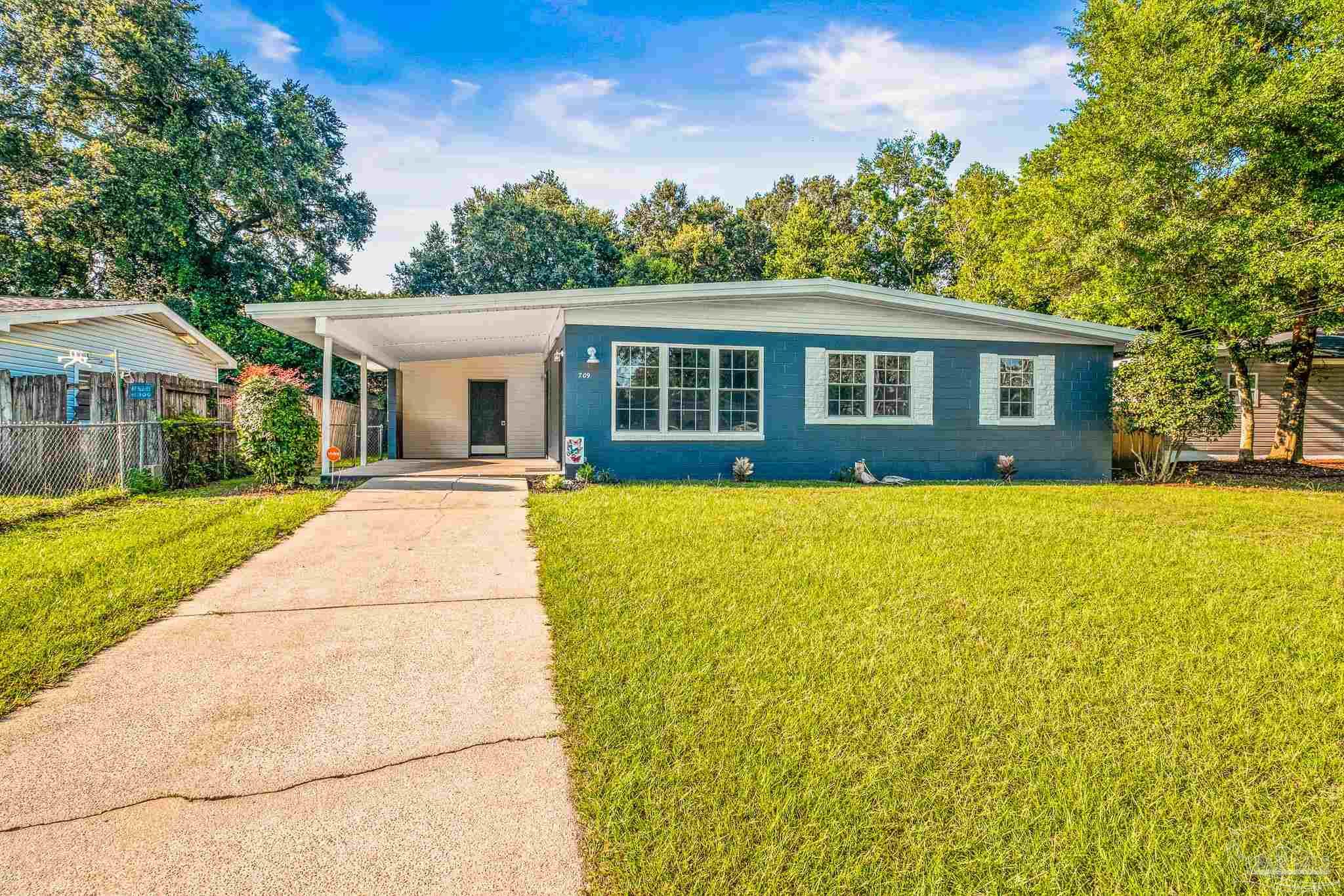 a front view of house with yard and green space