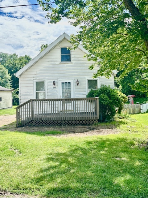 a view of a house with a yard and a fence