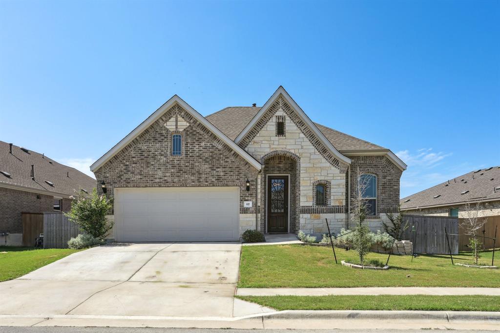 a front view of a house with a yard