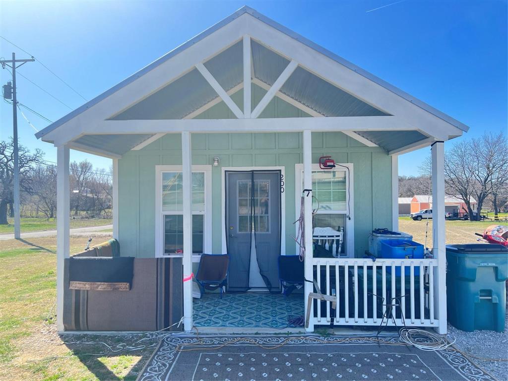 a view of a house with a porch and furniture