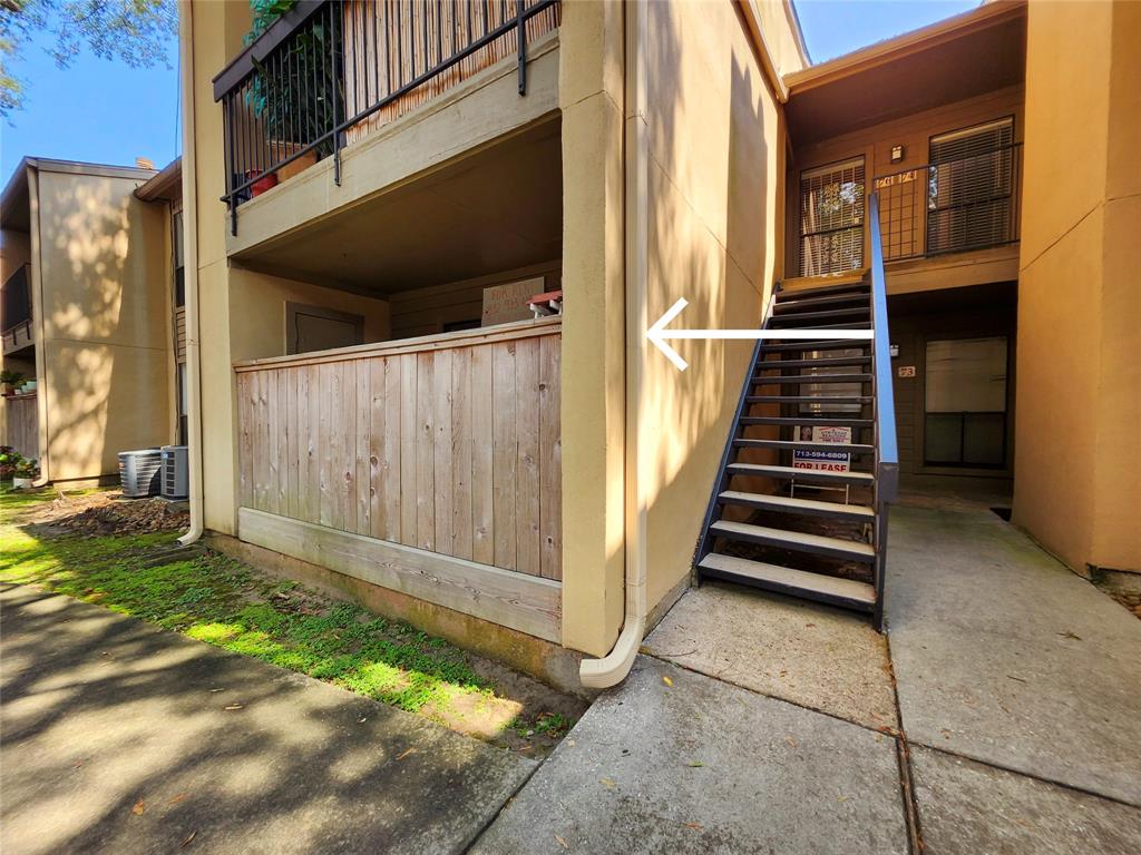 a view of a house with backyard and wooden door