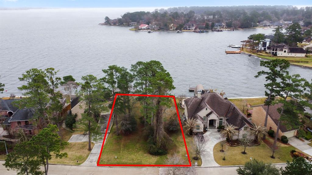 an aerial view of a house with a lake view