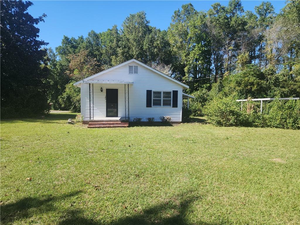 a front view of a house with yard and green space