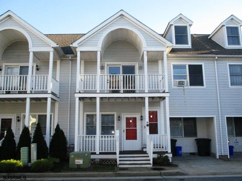 a view of a brick house with large windows