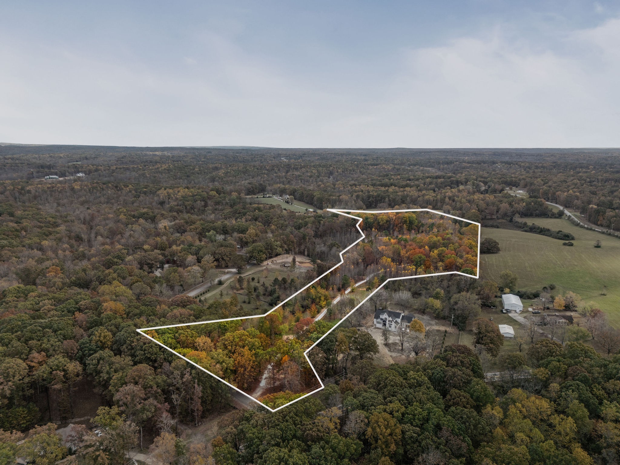 an aerial view of house with yard and ocean view