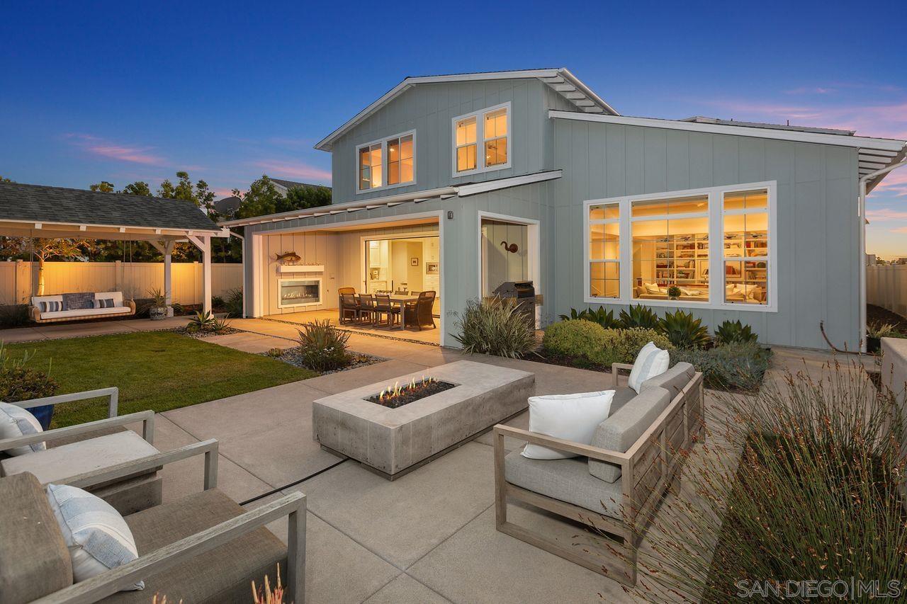 a view of a house with backyard sitting area and garden