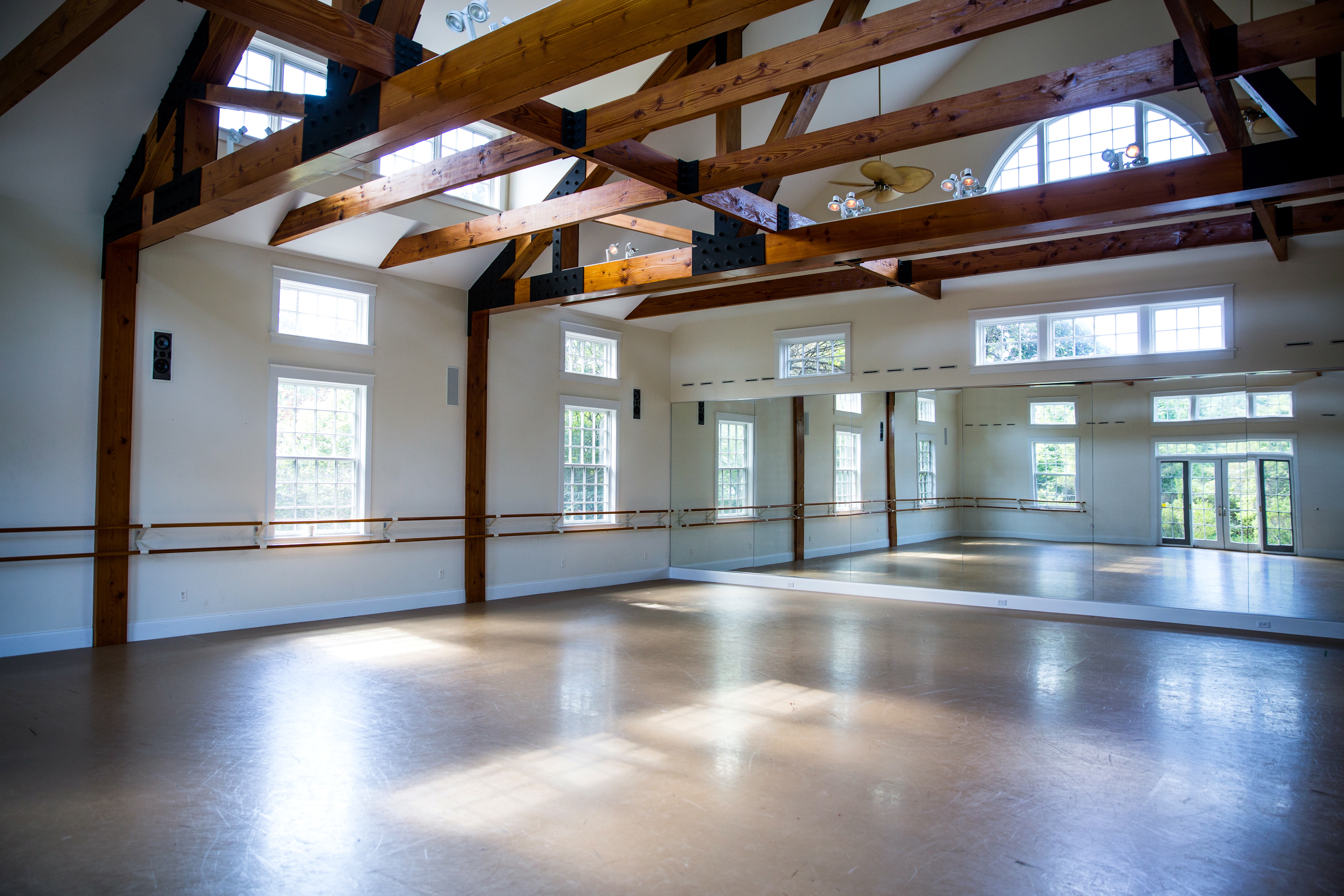 a view of empty room with stairs and wooden floor