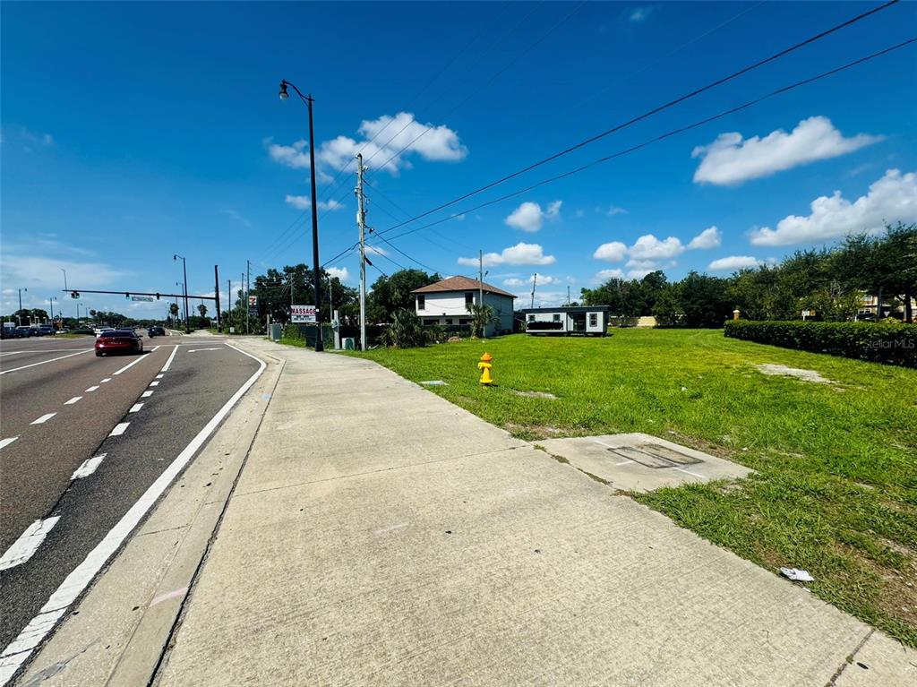 a view of a street with a yard