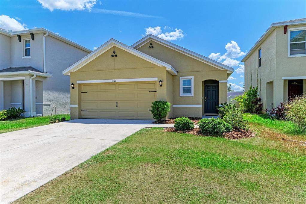 a front view of a house with a yard and garage