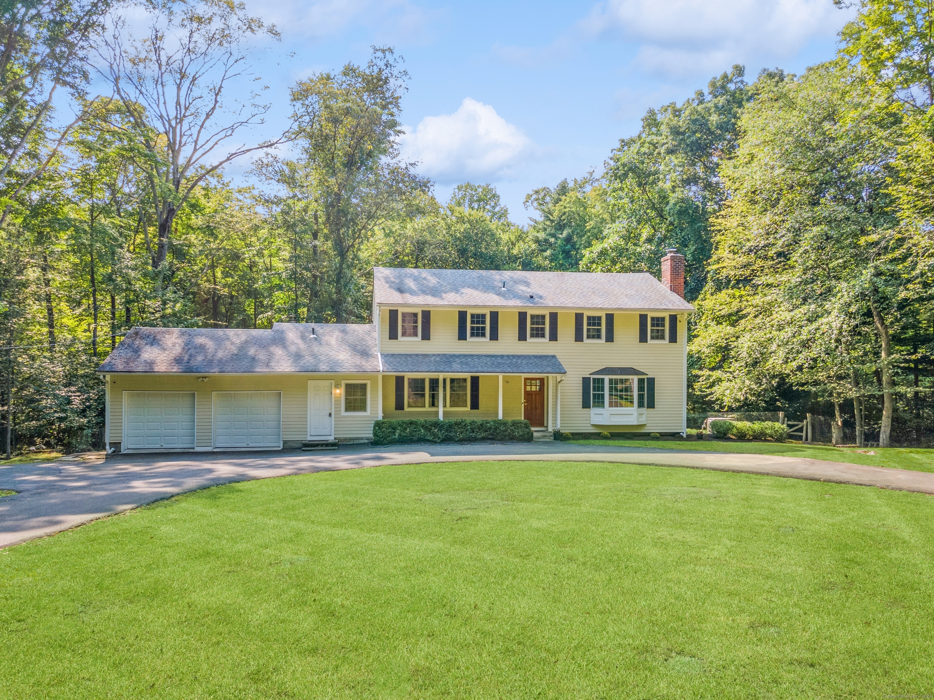 Front of 37 Hannahs with circular driveway and large, flat yard