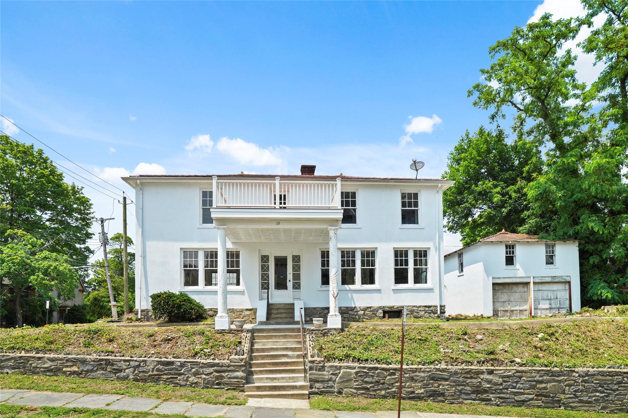 View of front of property with a porch and a balcony