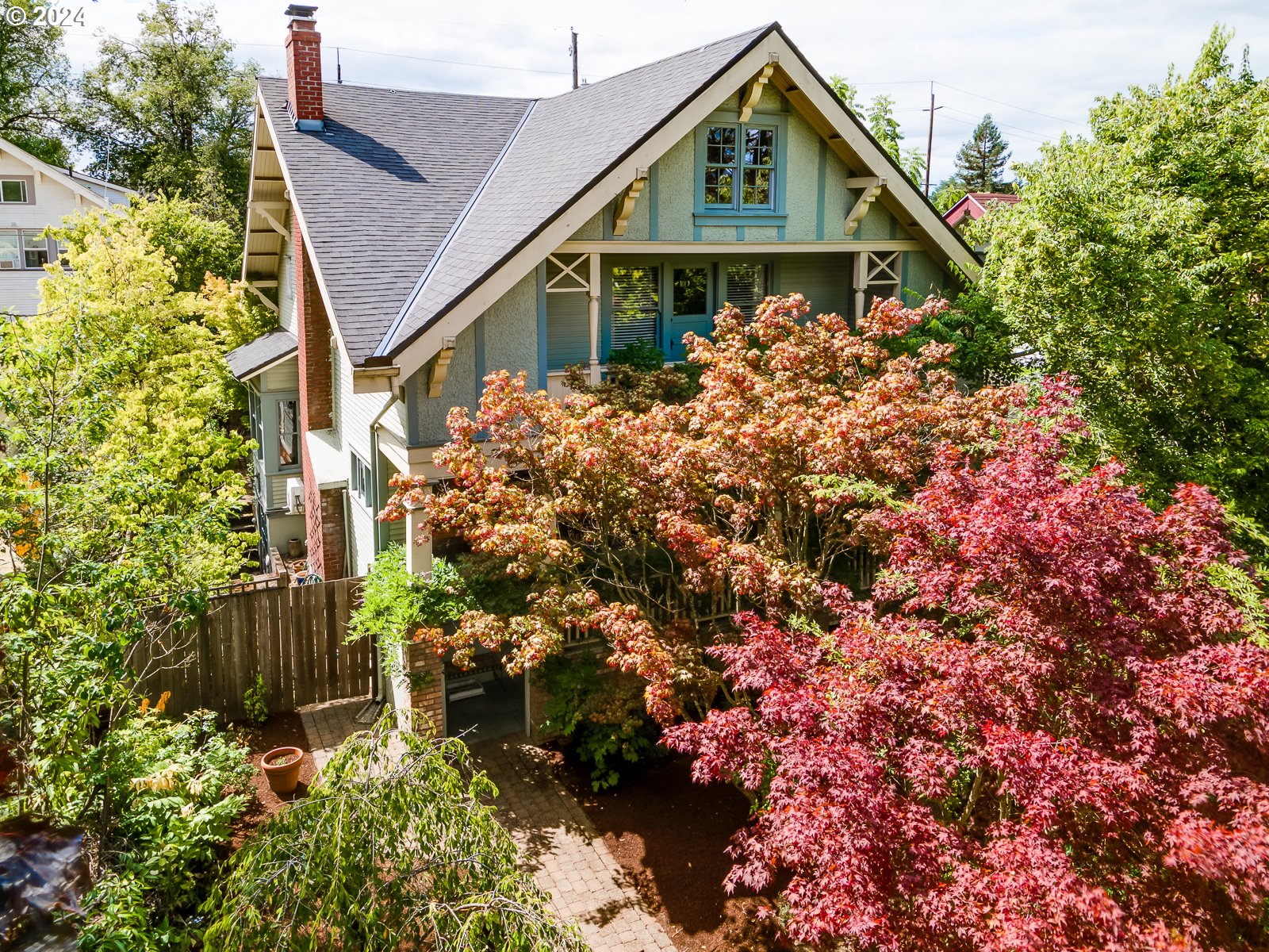 a view of a house with a small yard and garden