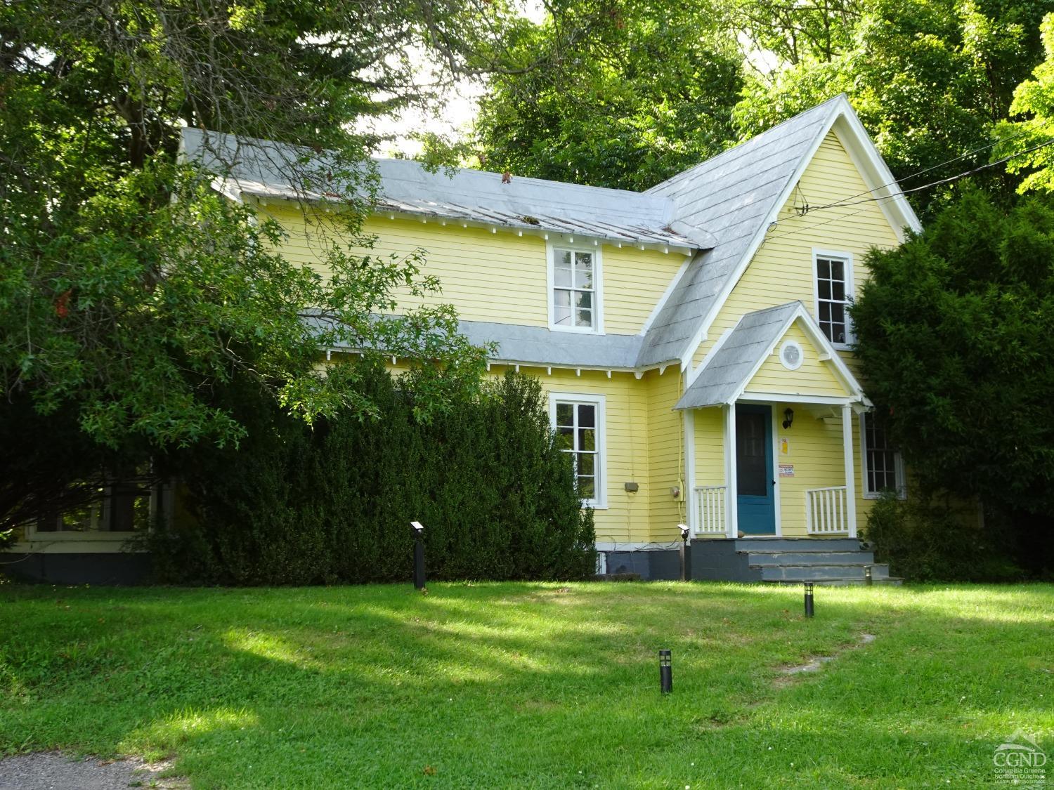 a front view of a house with a garden