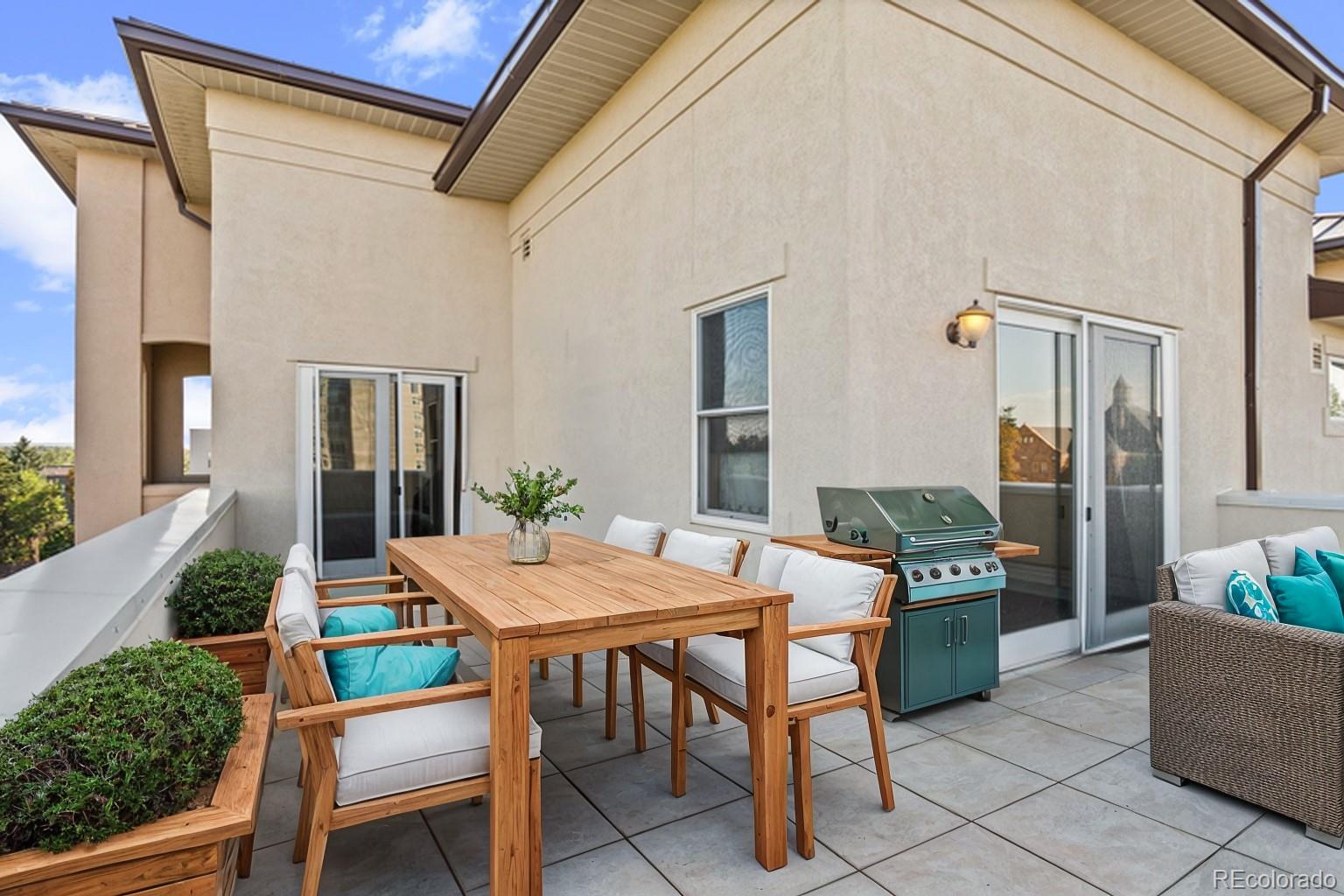 a view of an outdoor dining space with a table and chairs