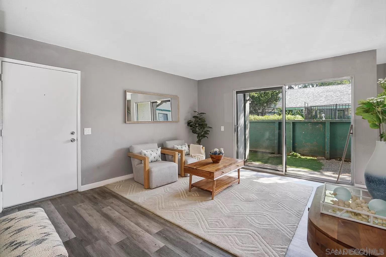 a bedroom with furniture and large windows