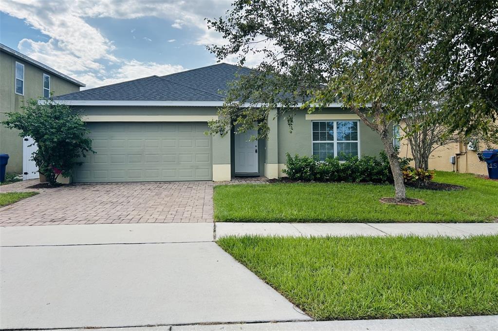 a front view of house with yard and green space