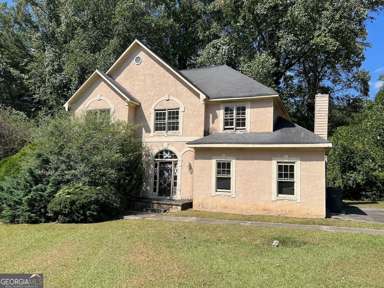 a front view of a house with a yard and garage