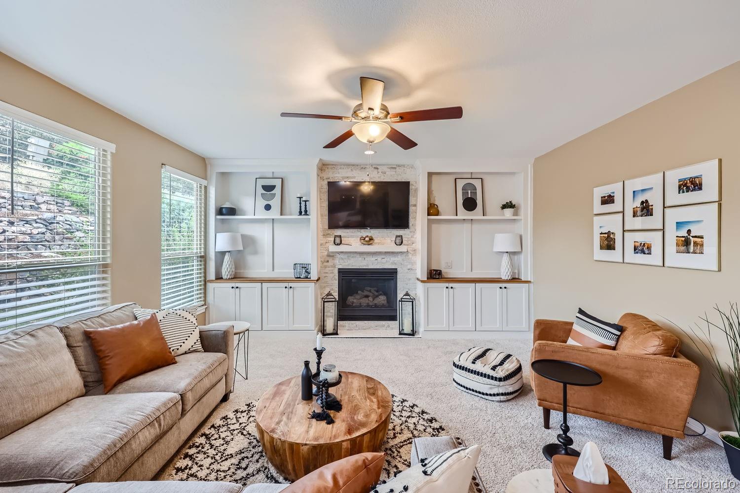 a living room with furniture a fireplace and a flat screen tv