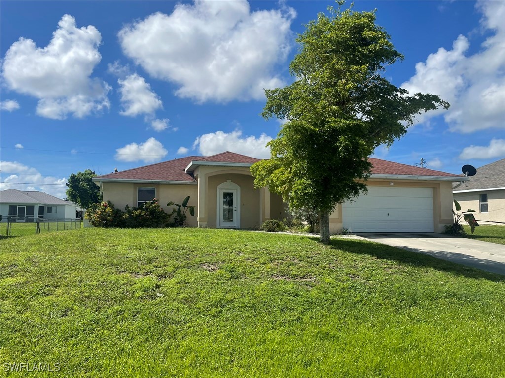 a front view of a house with a yard and garage