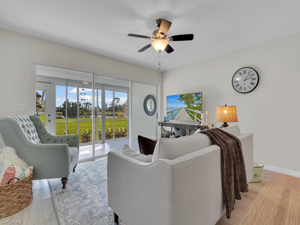 Living room featuring light wood-type flooring and ceiling fan