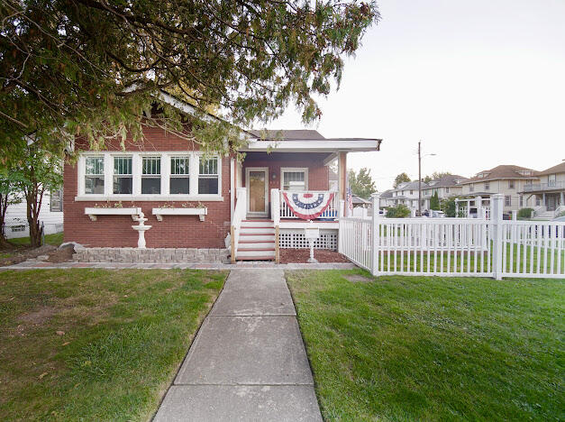 a front view of a house with a garden