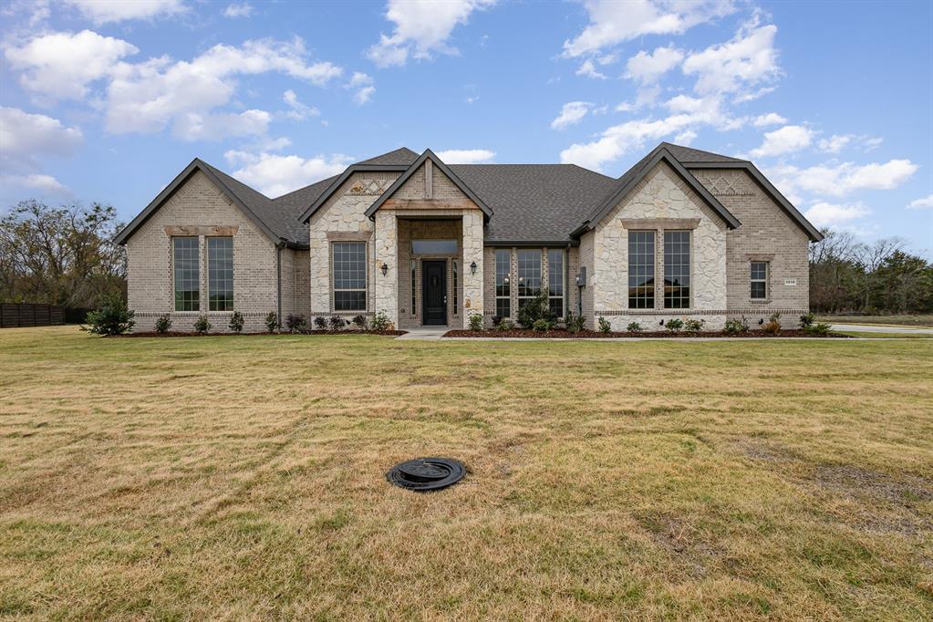 a front view of a house with yard