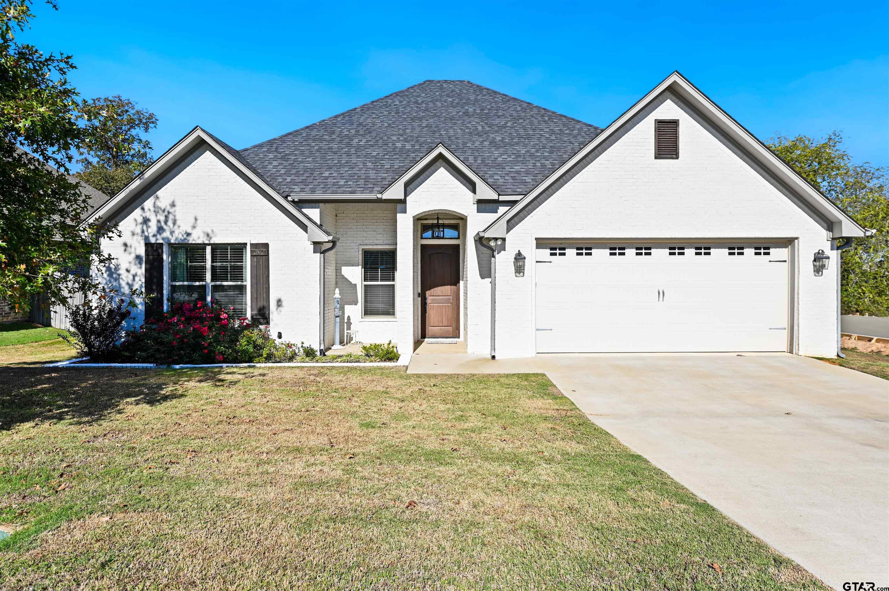 a view of a house with a yard and garage