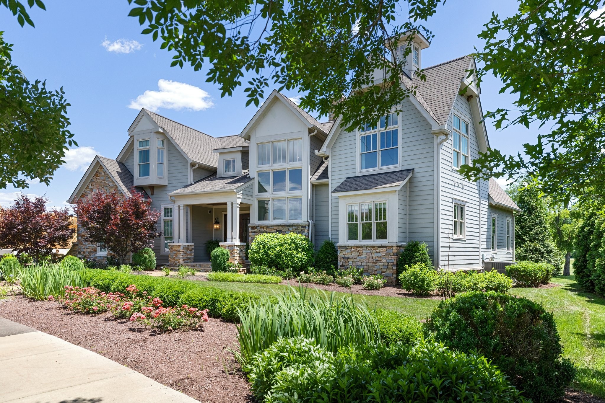 a front view of a house with a garden