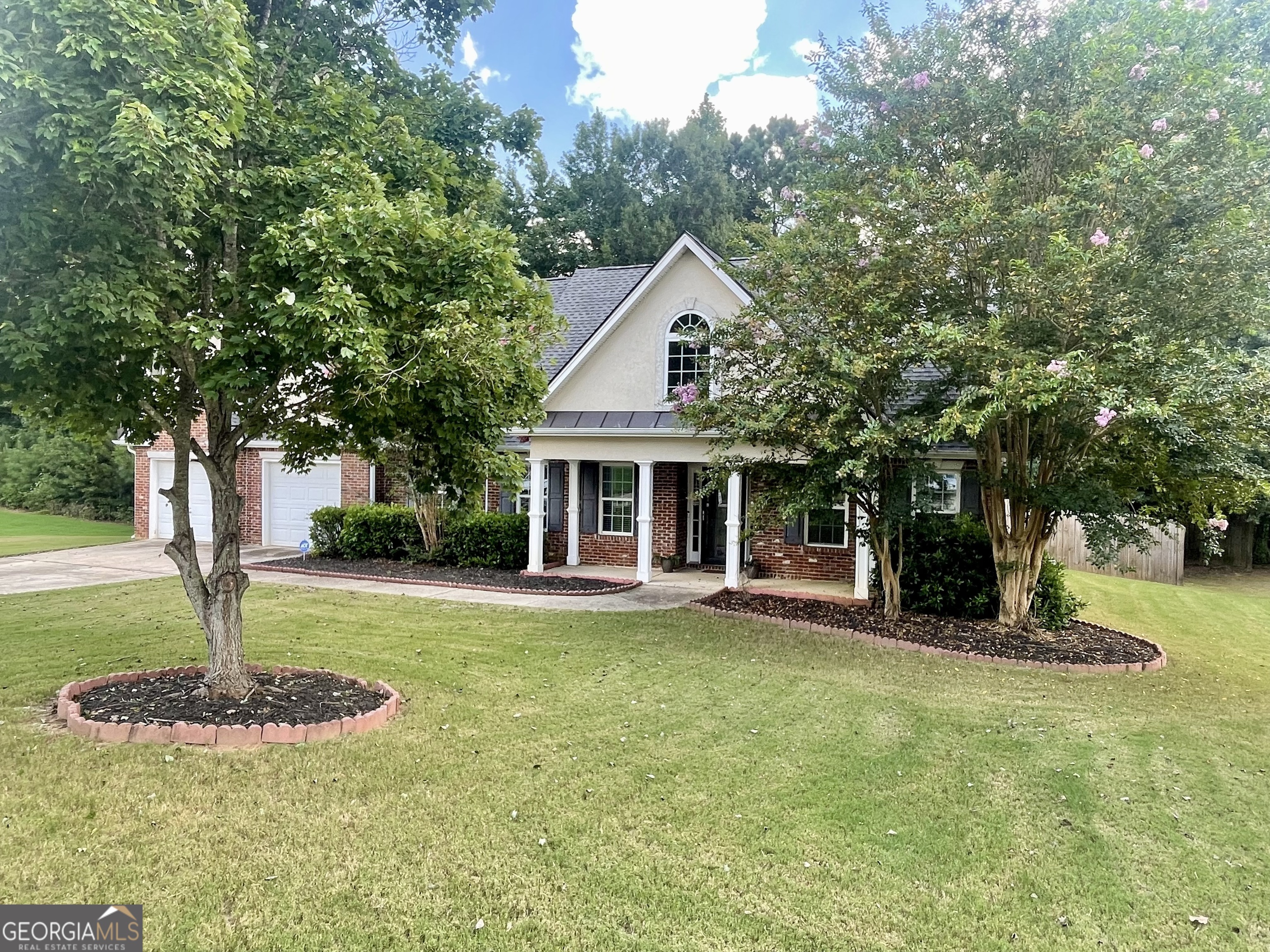 a front view of a house with a yard garage and outdoor seating