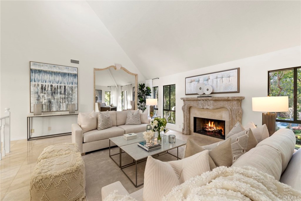 a living room with furniture and a fireplace