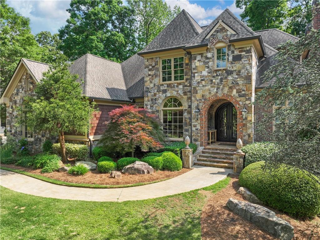 a front view of a house with a garden