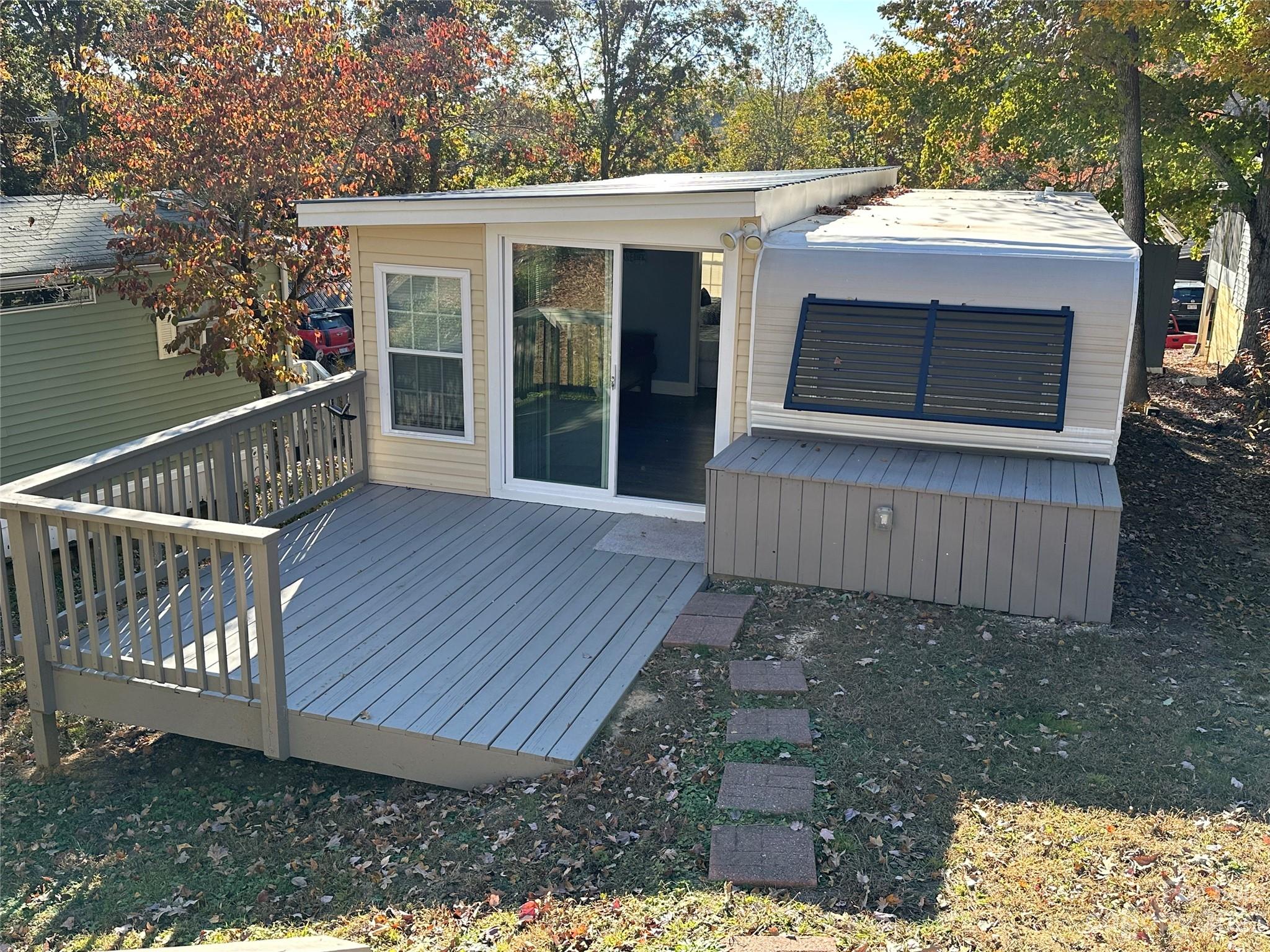 a view of backyard with deck and a garden