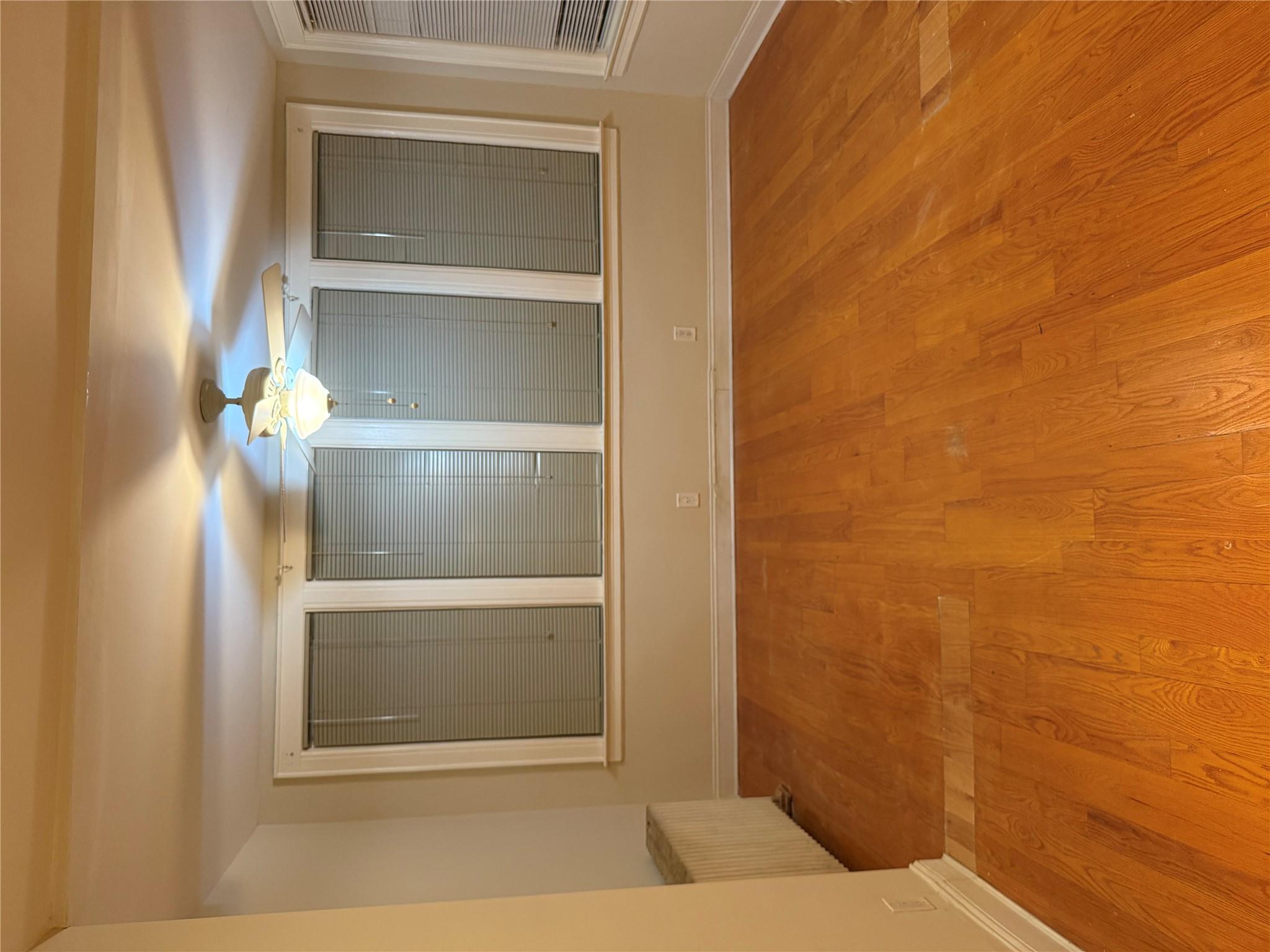 Spare room with radiator, ceiling fan, and light wood-type flooring