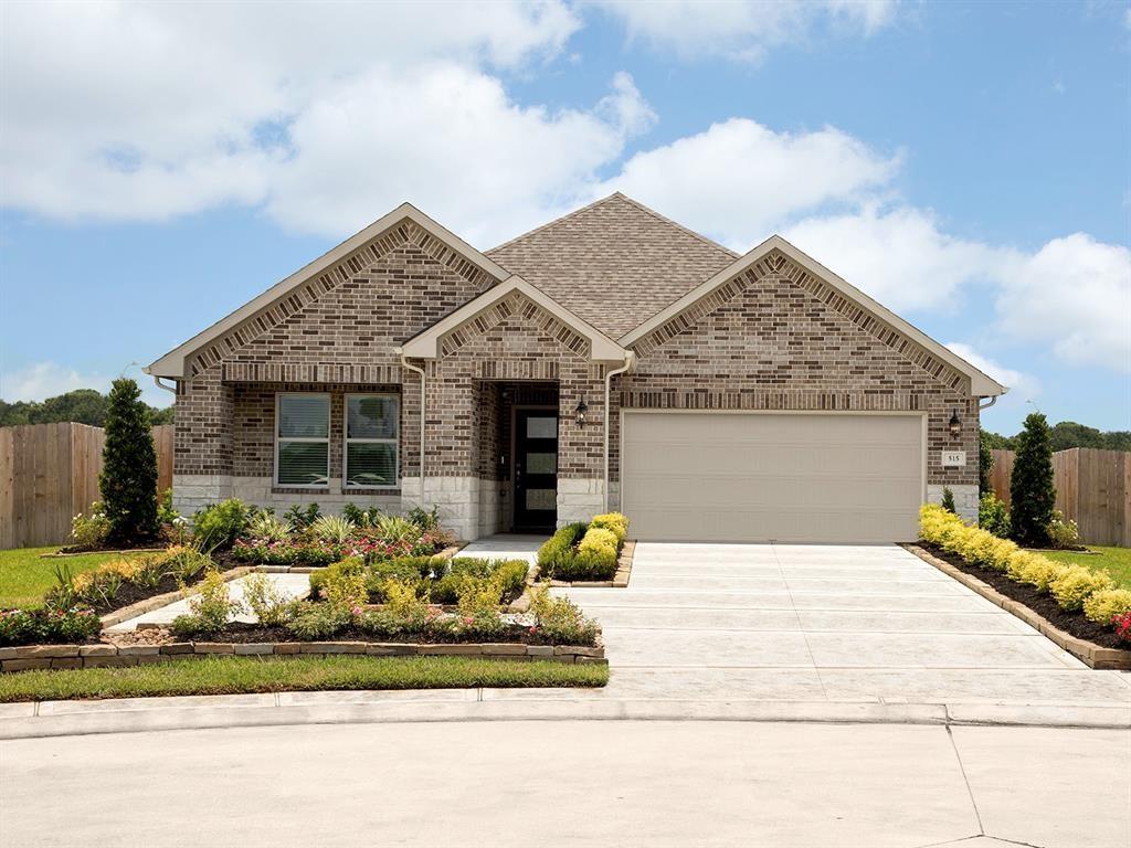 a front view of a house with a garden and outdoor seating