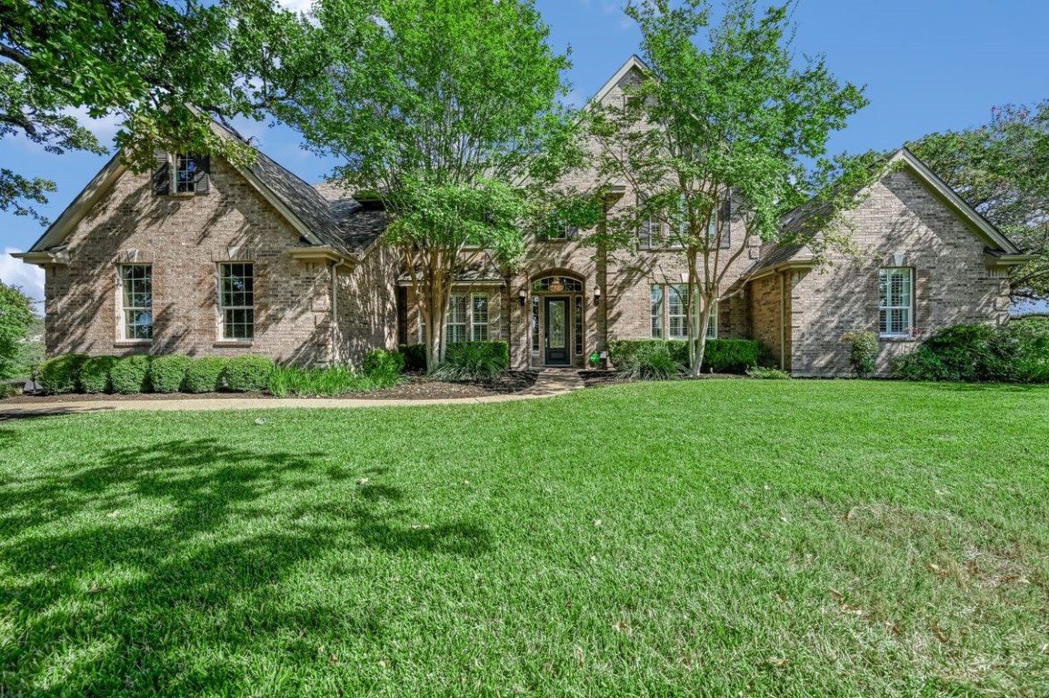 a front view of house with yard and green space