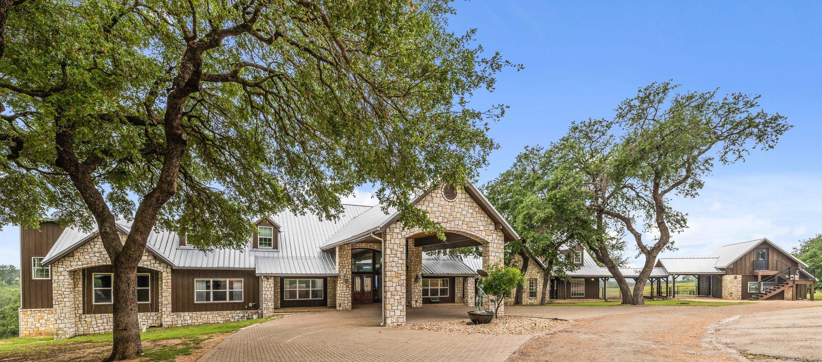 front view of a house with a tree in the background