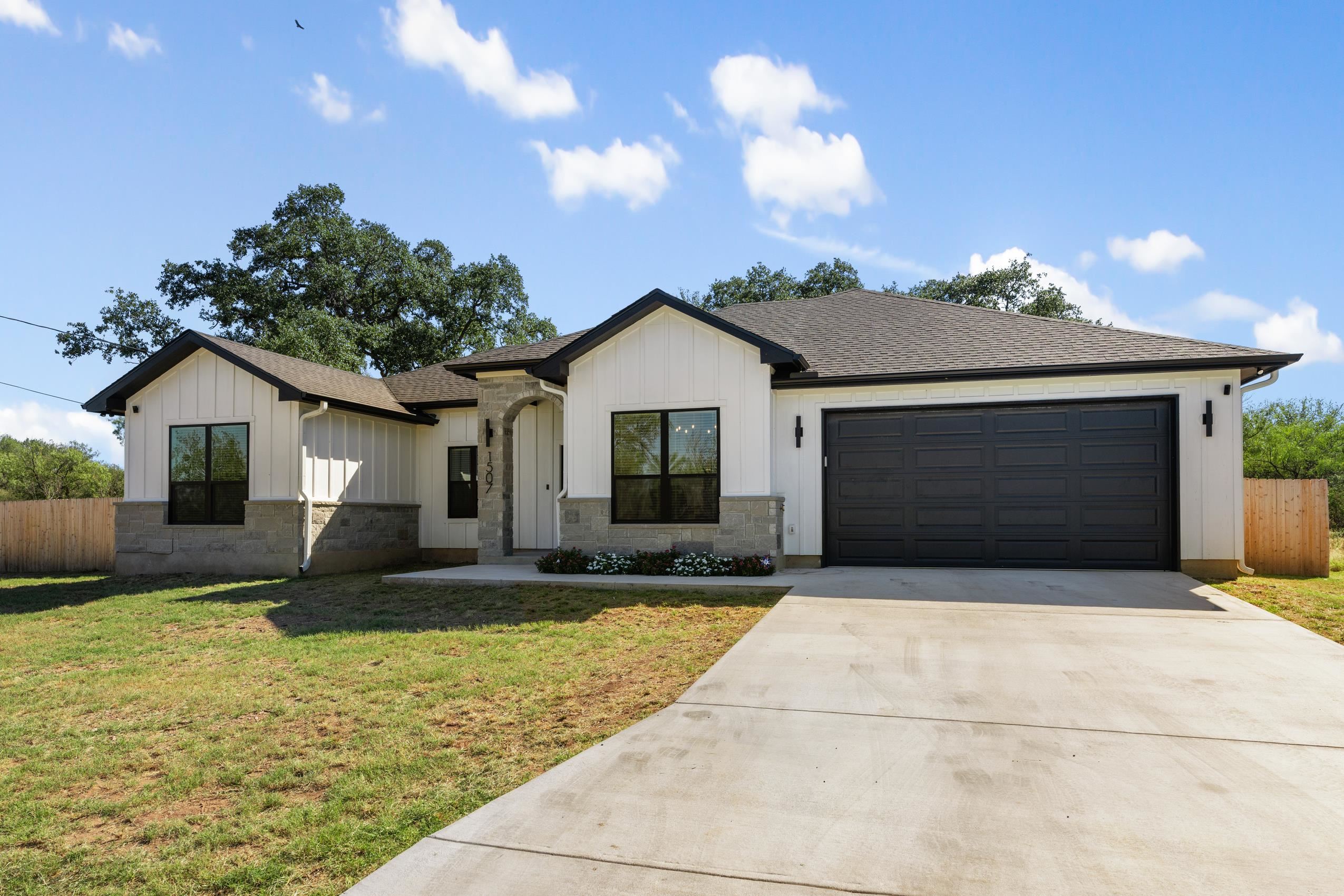 a front view of a house with a yard and garage