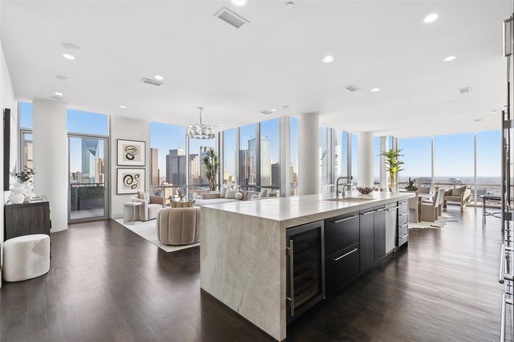 a kitchen with lots of counter top space and painting on the wall