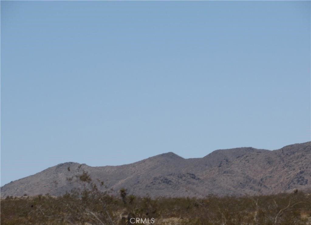 a view of a mountain range in a cloudy sky