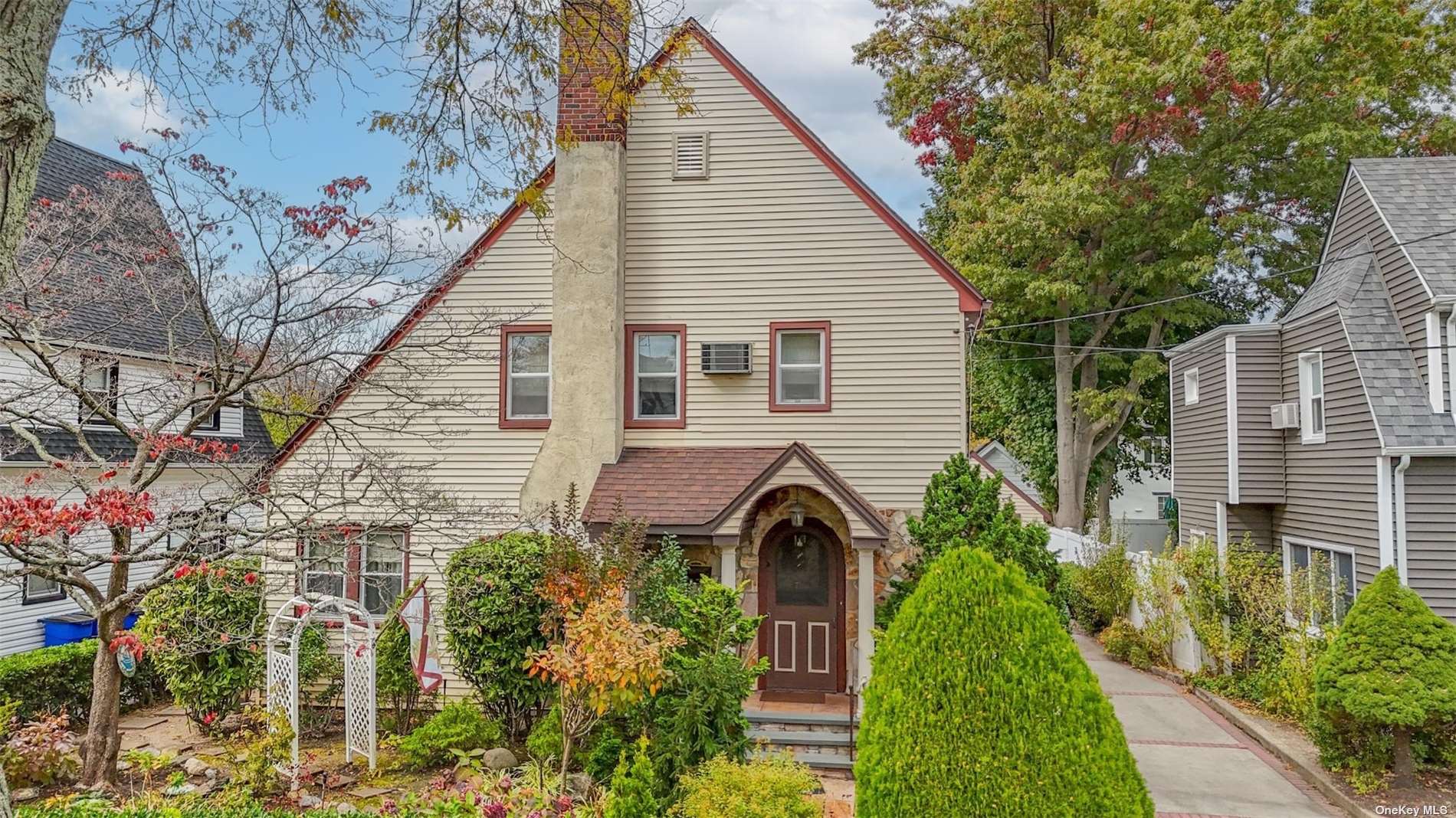 a front view of a house with a garden