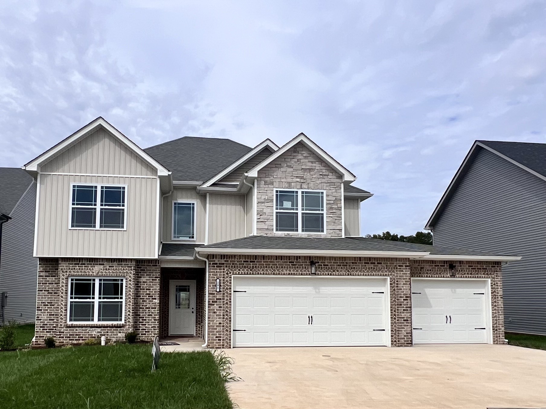 a view of a house with a yard and garage