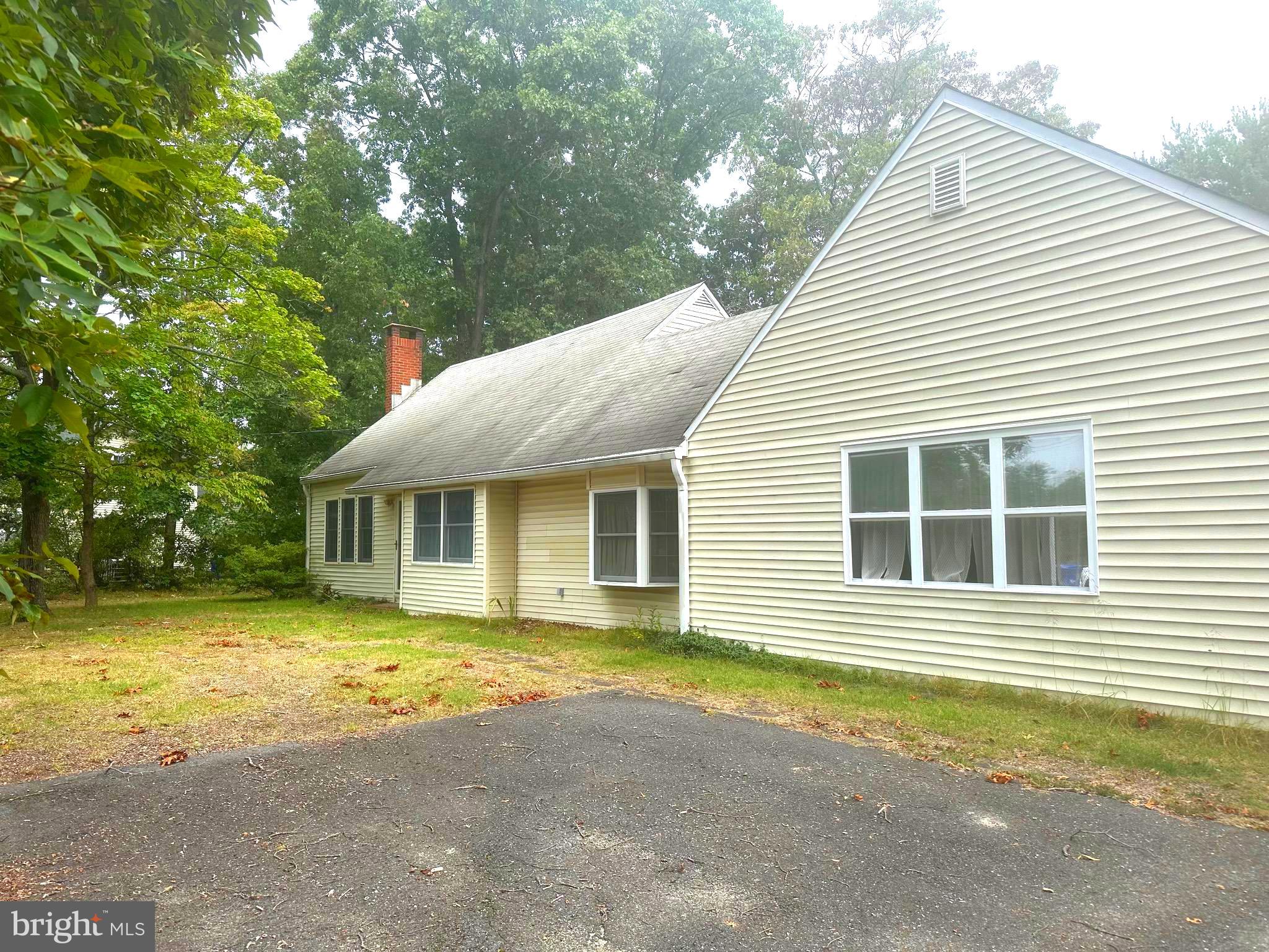 a view of a house with a yard and sitting area