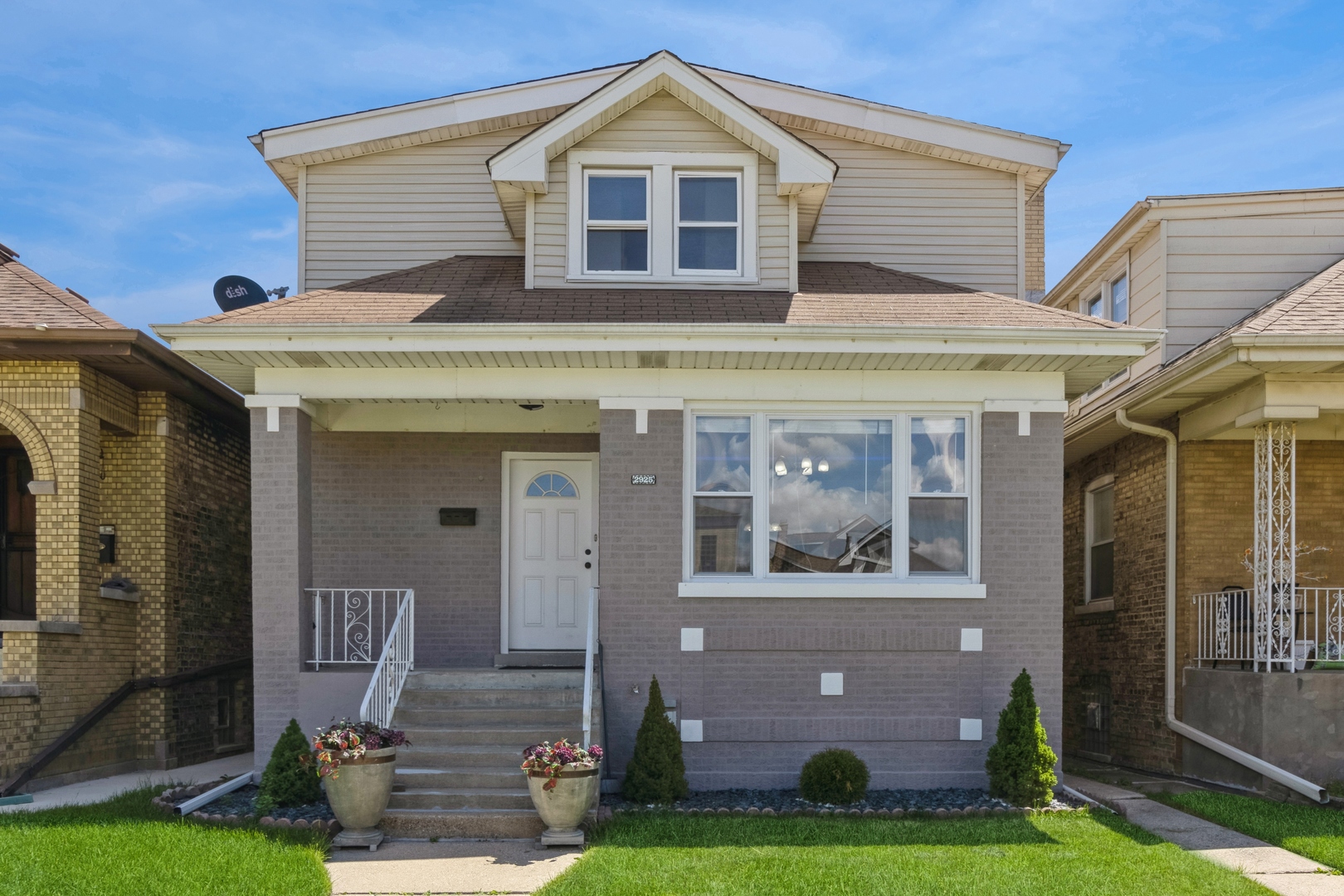 a front view of a house with garden