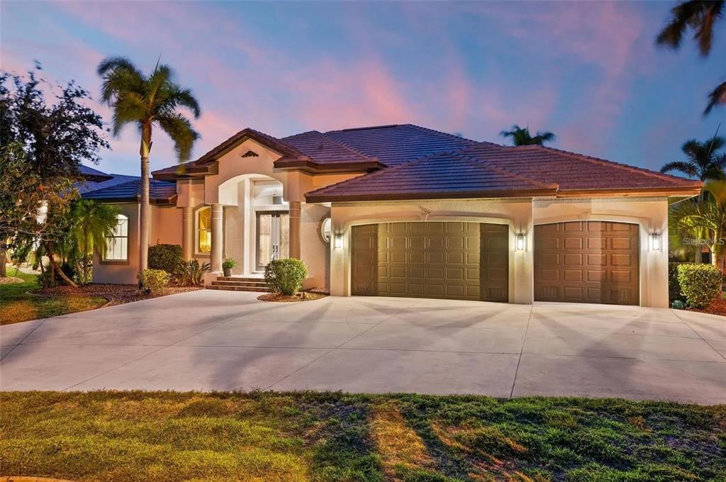 a front view of a house with a yard and garage