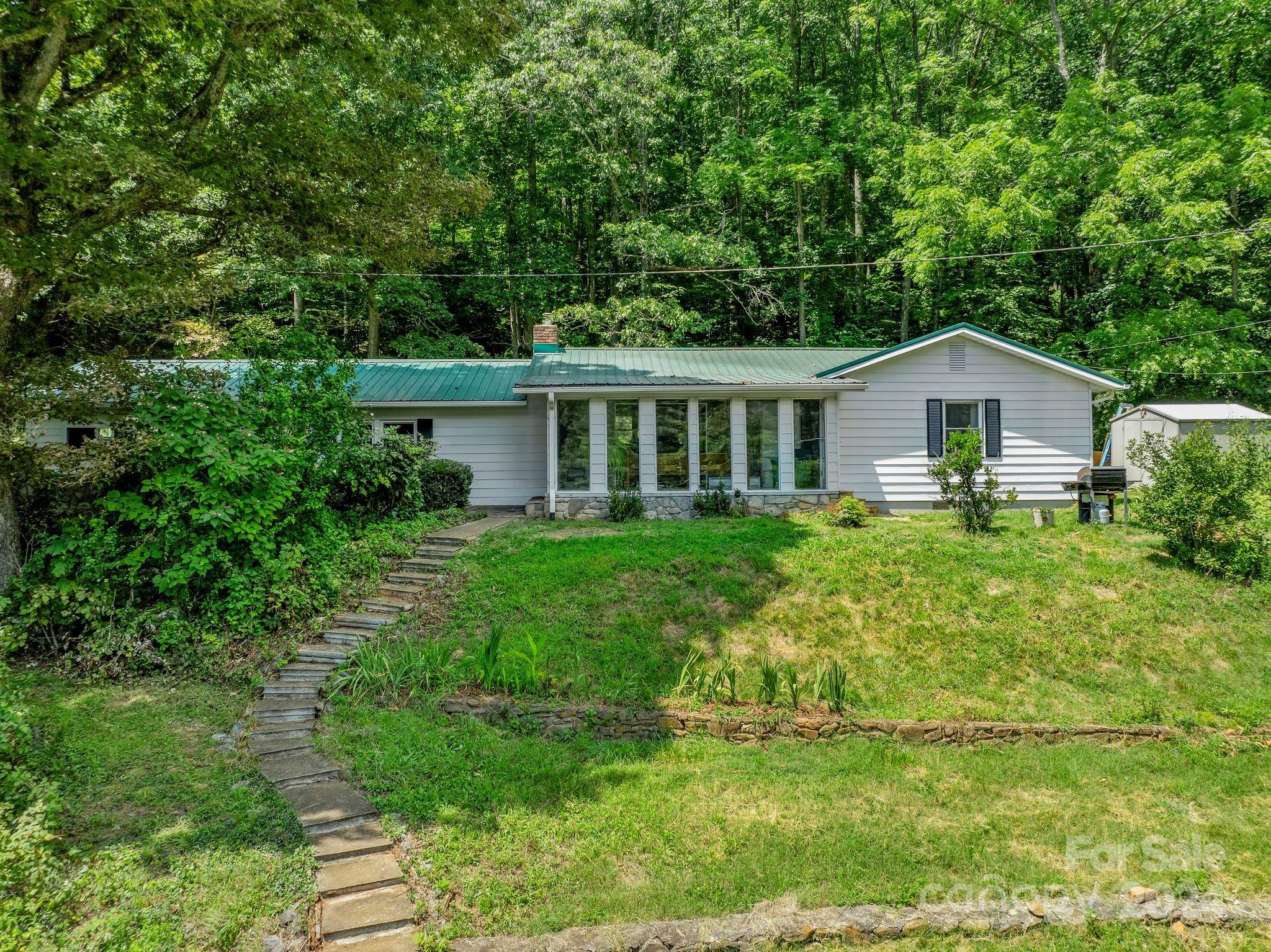 a front view of a house with a garden