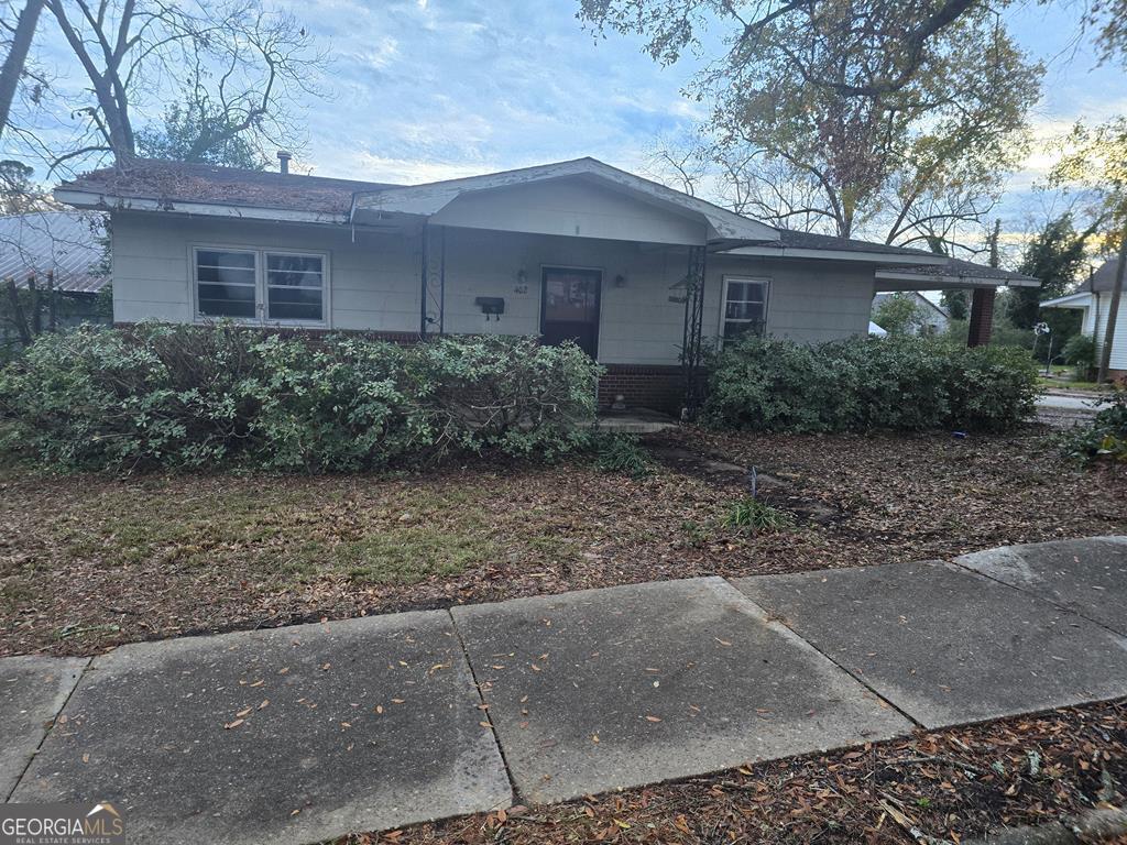 a front view of a house with garden