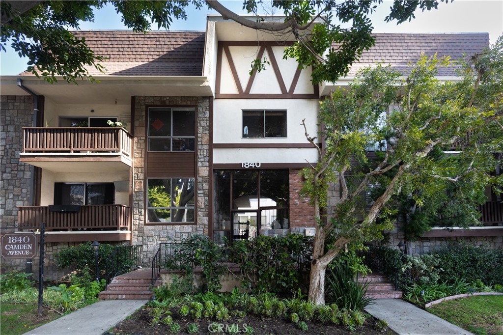 a front view of a house with plants