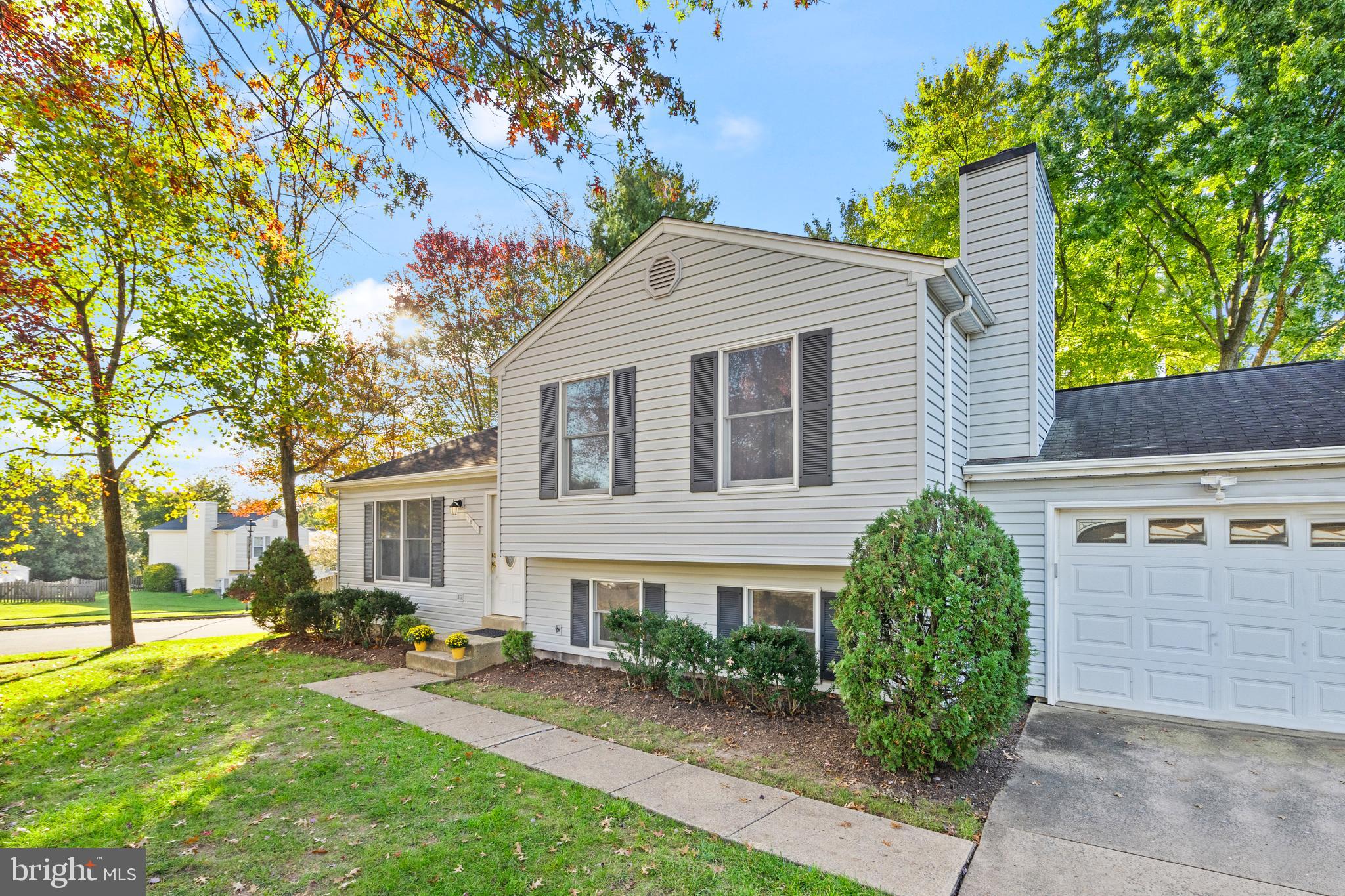 a front view of a house with a yard and potted plants