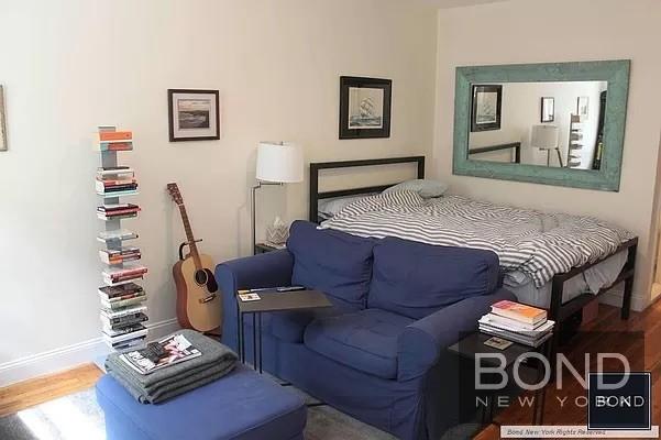 a bedroom with furniture and a wooden floor